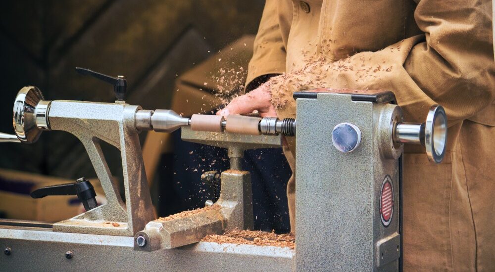 Woodturner crafting a piece on a wood lathe