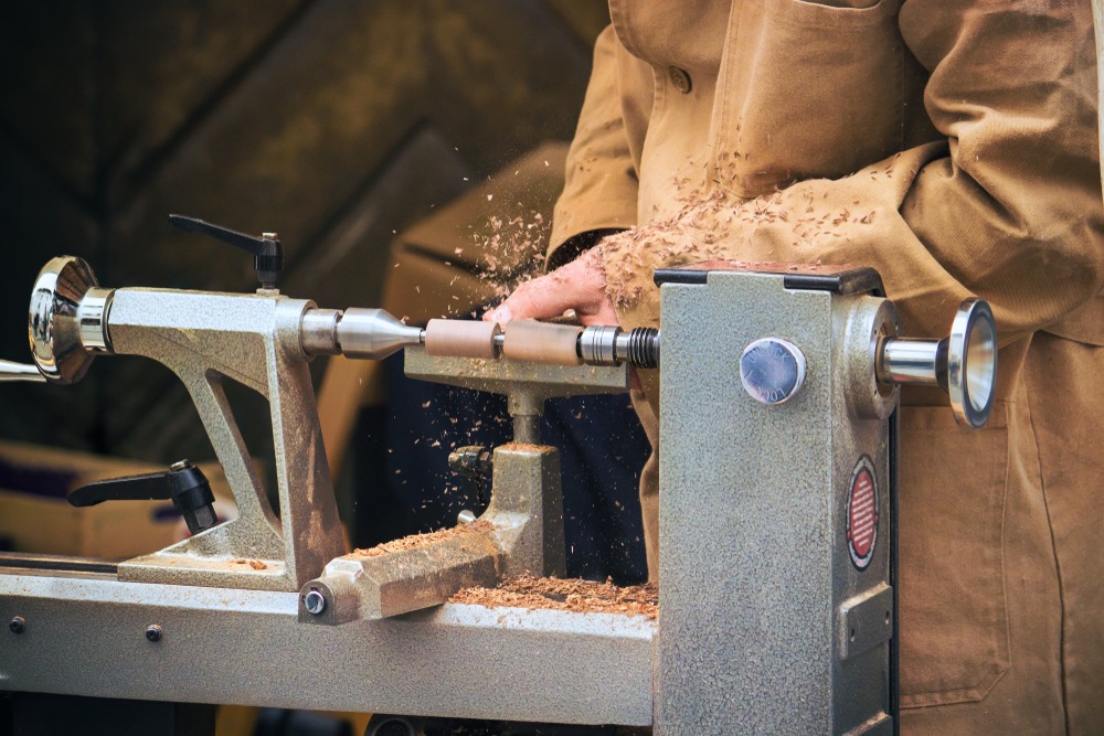 Woodturner crafting a piece on a wood lathe