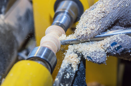 Piece of wood turning on lathe's spindle